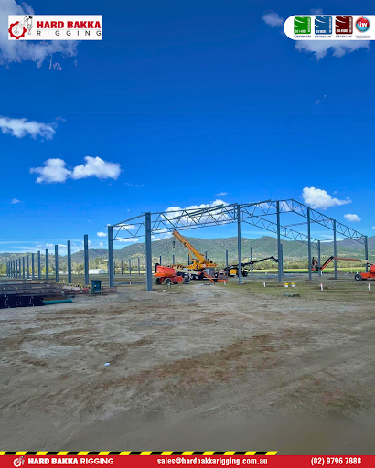 Hard Bakka Rigging team assembling structural steel framework for the JBR62 Techspan project in Kootingal under clear blue skies.