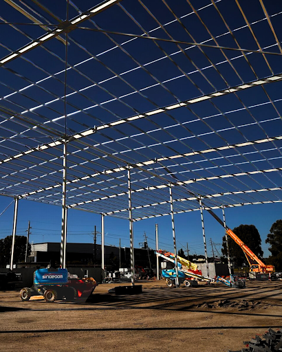 Steel framework installation at B&G LOGOs warehouse in Prestons by Hard Bakka Rigging, ensuring precision and structural integrity.