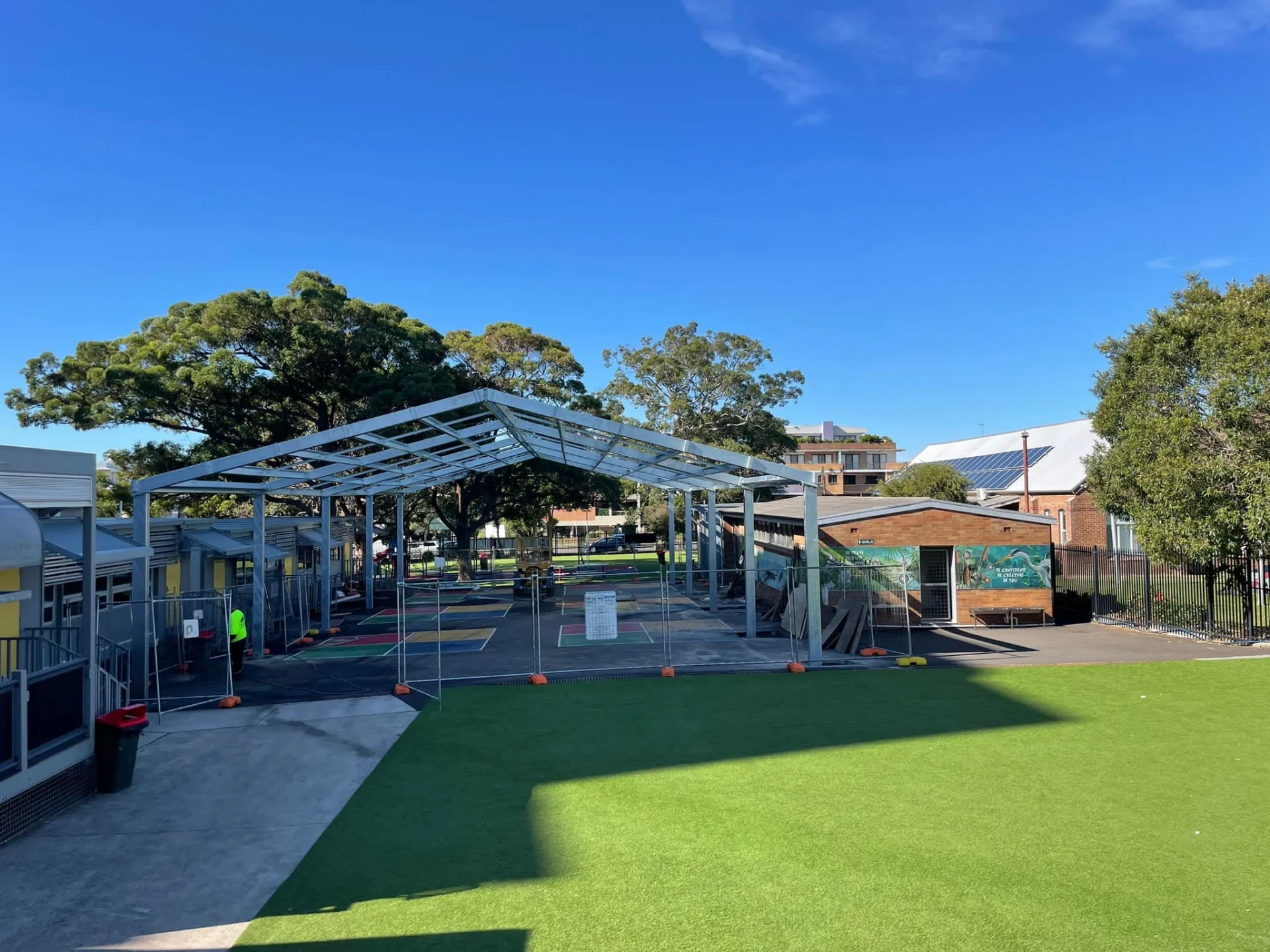 Steel shelter structure installed over a primary school playground at Kogarah Public School.