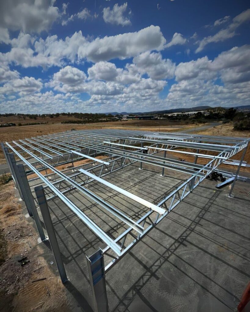 Structural steel framework under construction for Geko Warehouse in Kootingal, showcasing lift planning techniques for product storage and commercial facilities.