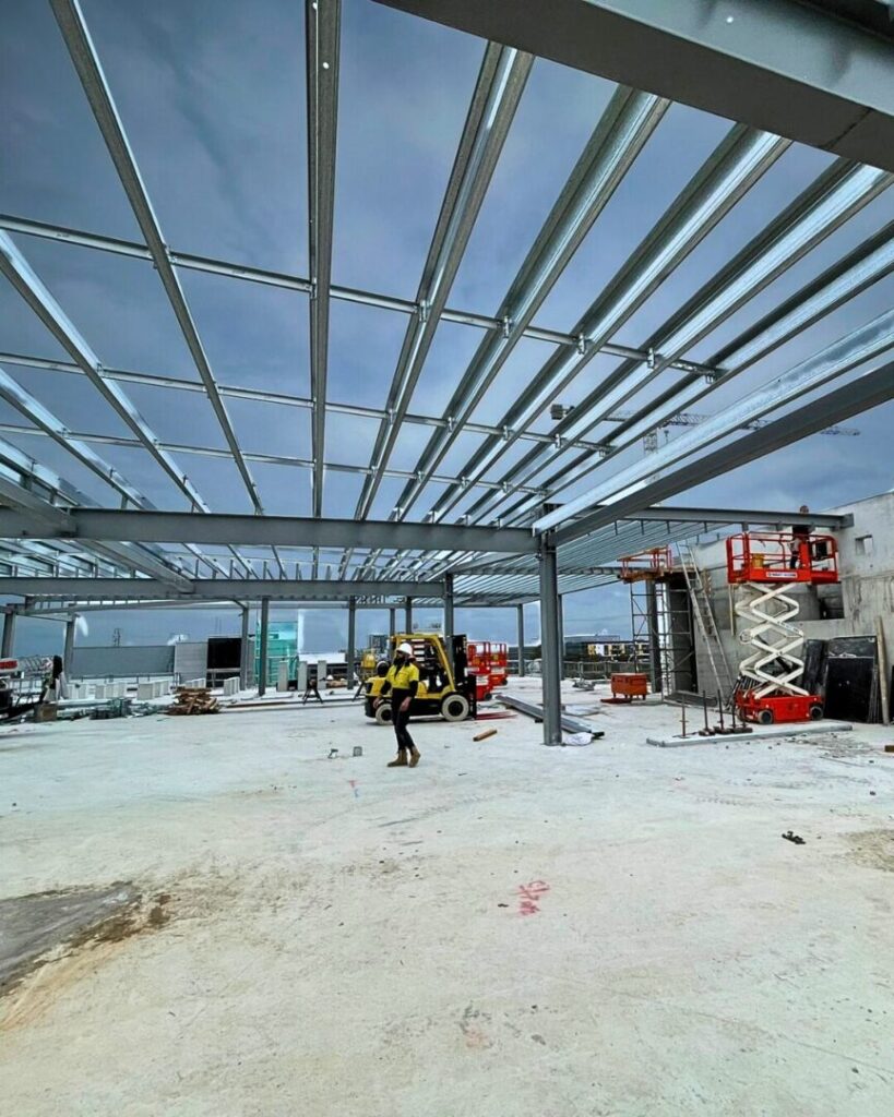 Rigging in construction and industry at Macquarie Park, assembling the steel framework for an office complex designed to house mechanical machinery.