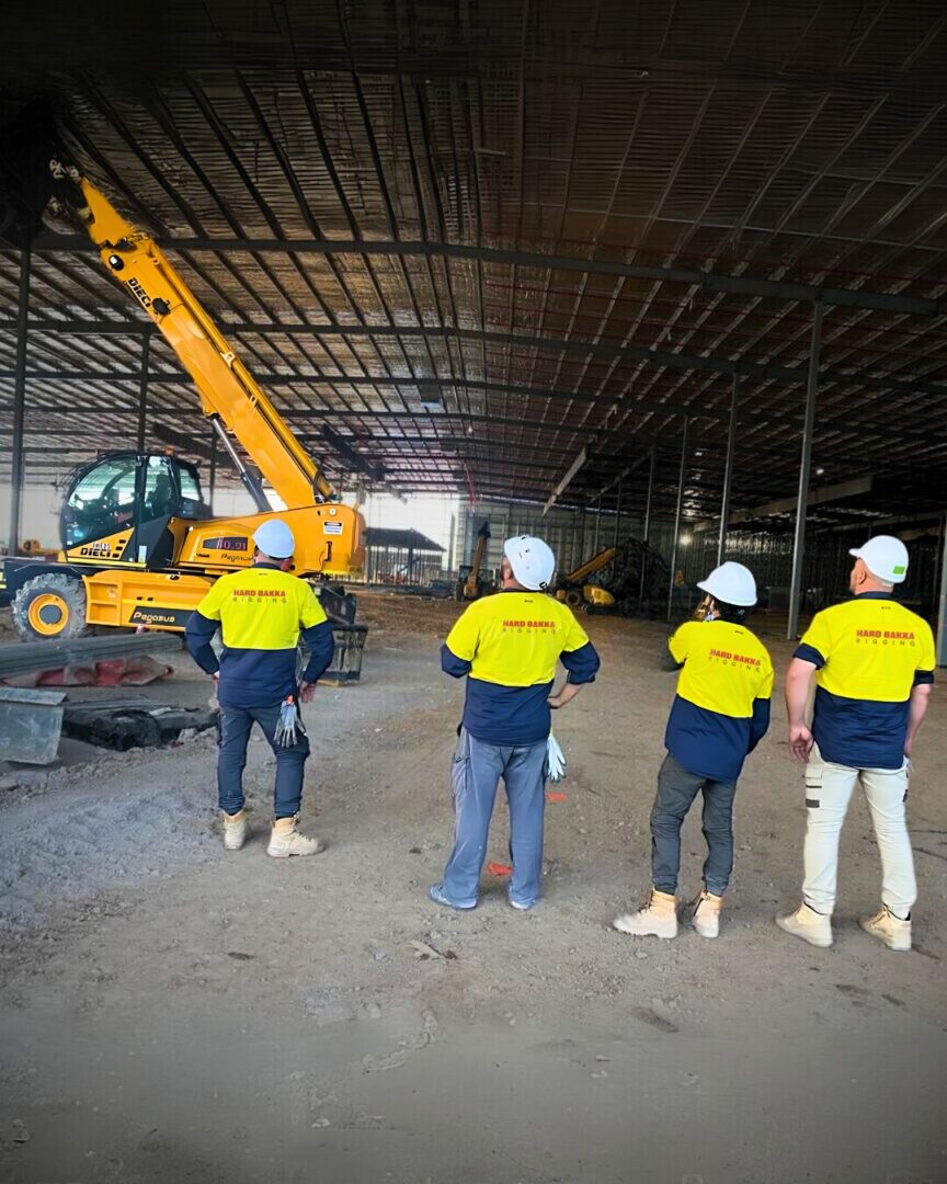 Hard Bakka Rigging crew overseeing steel installation at API Medical Storage Warehouse in Marsden Park, with a telehandler lifting materials into place.