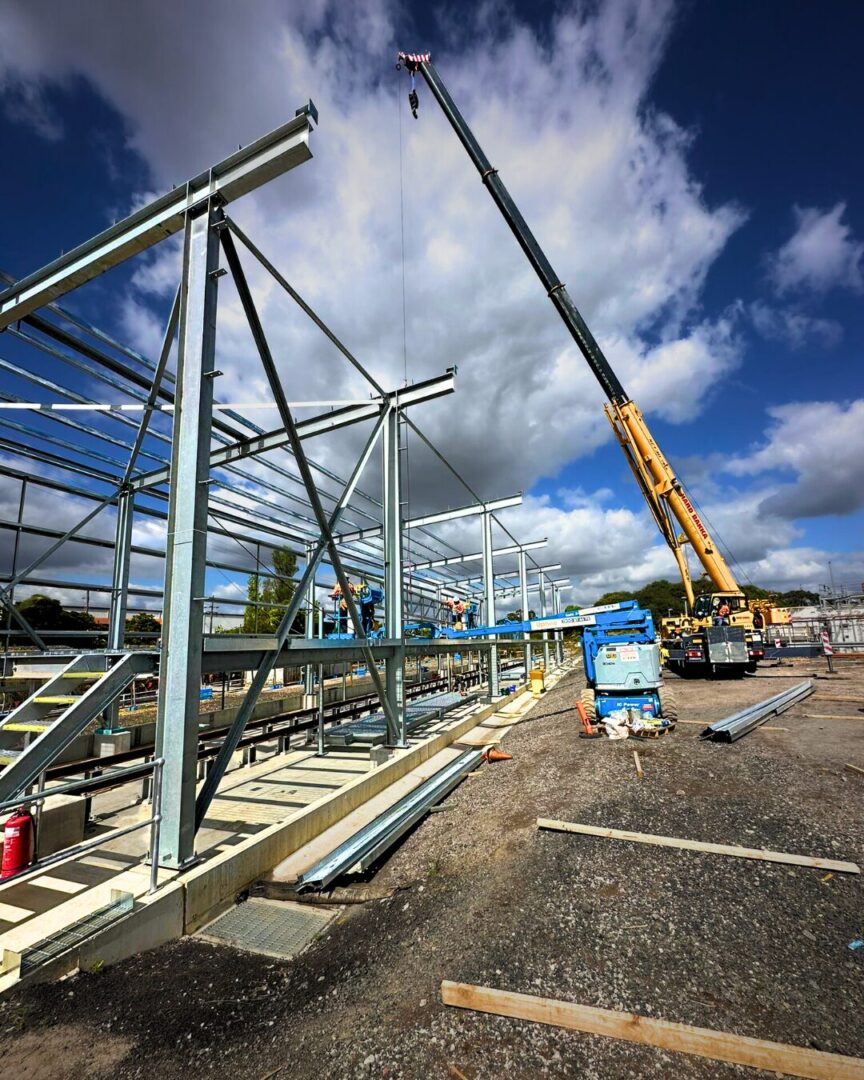 Structural steel erection at Chullora Train Maintenance Shed by Hard Bakka Rigging using mobile crane and EWP.