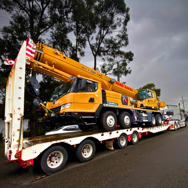 Hard Bakka Rigging's 30-tonne mobile crane loaded on a transport truck, showcasing its powerful and versatile lifting capabilities.